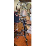 An Arts and Crafts style copper and brass teapot and warmer, on a painted cast metal stand, 88 cm
