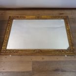 A carved wood and gesso wall mirror, 82 x 118 cm