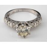 An 18ct white gold and diamond ring, the central stone of approx. 1ct, with six diamonds to the
