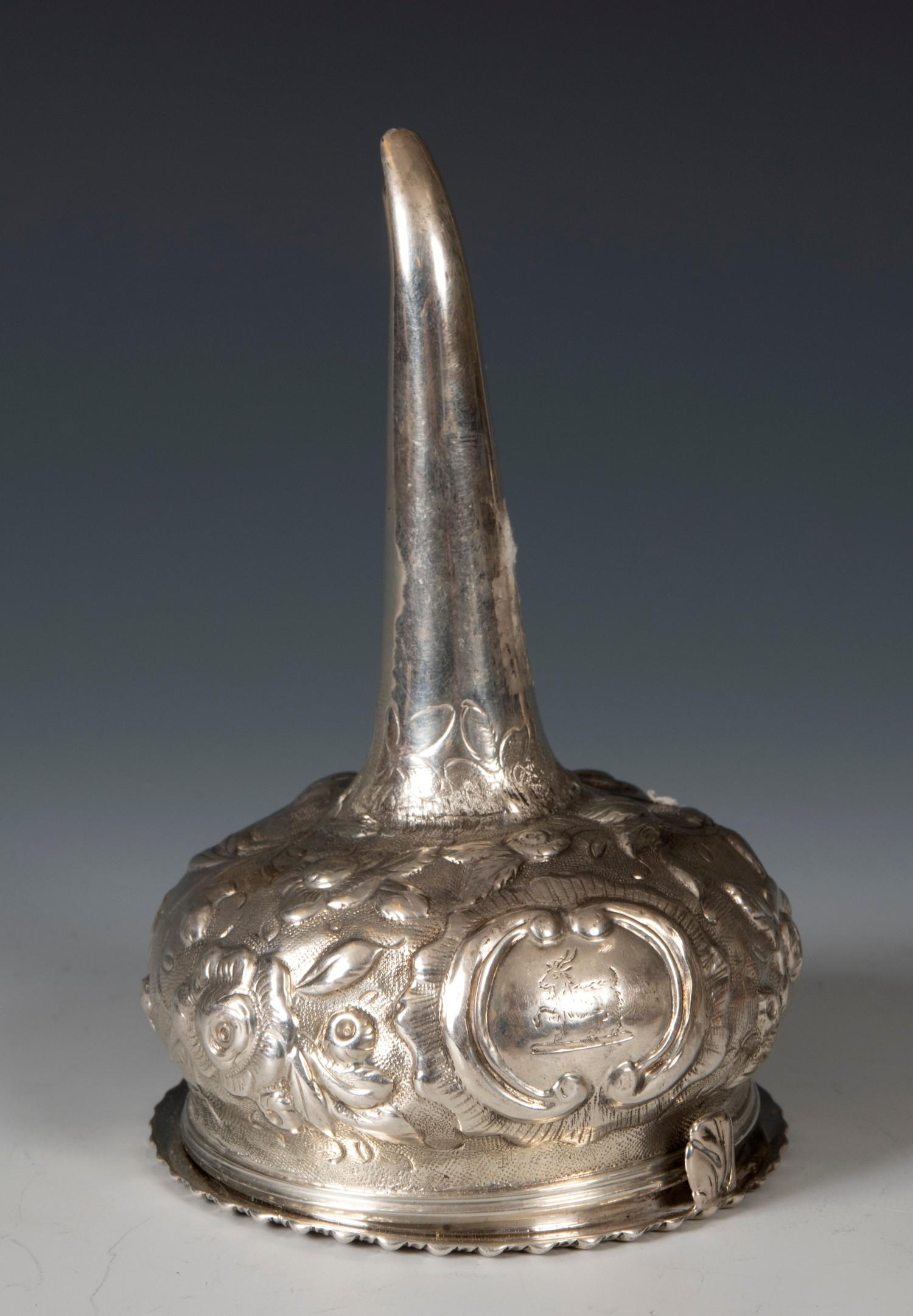 A George III silver wine funnel, crested, and with embossed decoration, London 1810, 12.5 cm high
