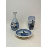 A Royal Copenhagen vase, 18 cm high, another, a figure of a bird, a pair of blue and white lamps,