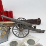 A tin plate toy cannon, an AA badge, fire side items, and a small collection of coins (box)