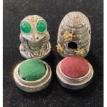 A silver beehive thimble, a pin cushion box, and a silver plated frog pin cushion Modern