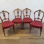 A set of four 19th century walnut chairs, with pierced splat backs to padded seats on turned legs (