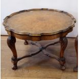 A 1920s walnut coffee table, on carved scroll legs, 75 cm diameter