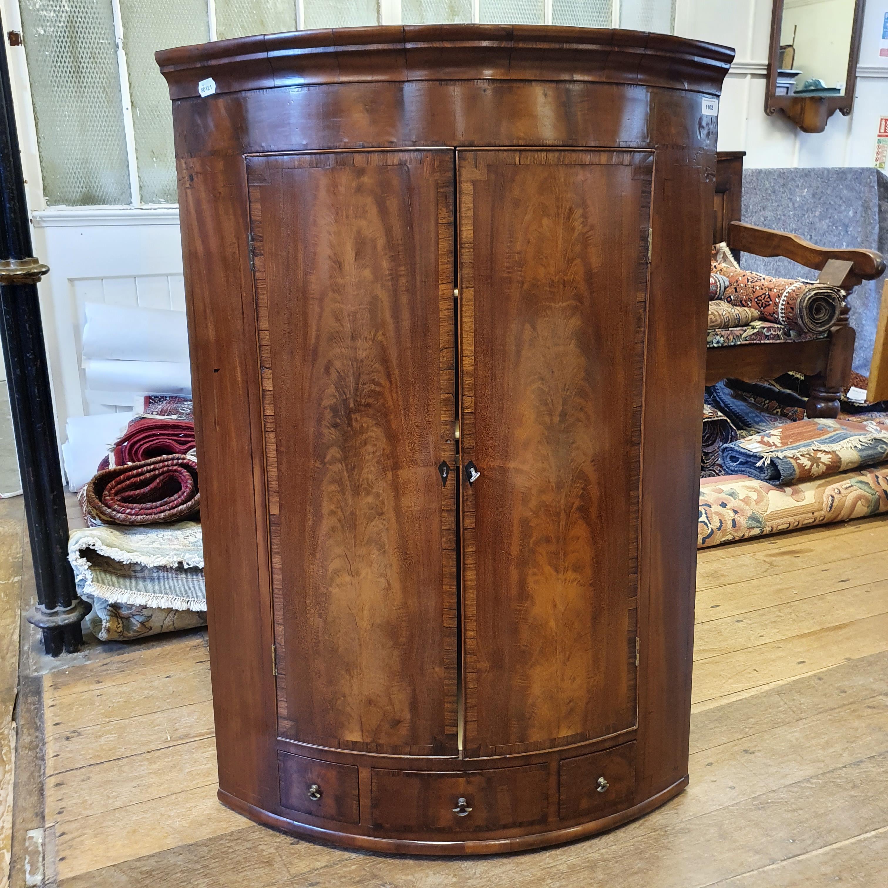 A 19th century mahogany bow fronted corner cabinet, having two drawers above three drawers, 80 cm