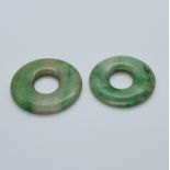 Two small mutton fat jade disks, the largest 2.5 cm diameter