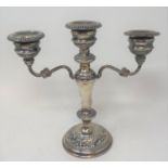 A 19th century style silver three light candelabrum, with embossed decoration, loaded, Birmingham