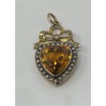 An Early 20th century 9ct gold, citrine and seed pearl, heart shaped pendent, 3.5 cm high overall,
