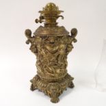 A brass oil lamp, lacking shade, decorated heraldic forms, 64 cm high