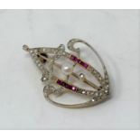 An Art Noveau ruby, diamond, and pearl brooch 3.5 cm tall