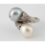 An early 20th century white coloured metal, diamond and cultured pearl crossover ring, ring size J