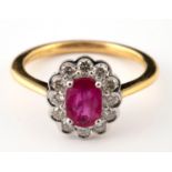 A 18ct gold oval-cut ruby and diamond cluster ring, ring size M Ruby 0.8ct and Diamonds 0.4ct