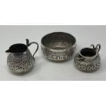 An Indian silver coloured metal cream jug, with a Cobra snake handle, 8 cm high, another similar,