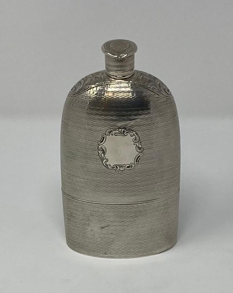 A large Victorian silver flask, with engraved decoration, and detachable cup, London 1851, 7.4