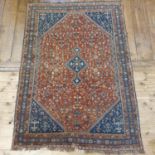 A Persian red ground carpet, multiple borders, centre with repeating geometric forms, 126 x178 cm