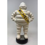 A painted metal Michelin man figure, standing on a wheel, 38 cm high Modern
