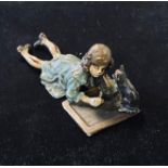 A painted bronze group, of a young girl and a cat, 10.5 cm wide Modern