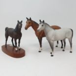 A Beswick figure of a grey horse, matt, a chestnut horse, matt, and a bay pony, matt (3)