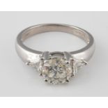 An 18ct white gold and brilliant cut diamond ring, the shoulders set trillion cut diamonds, ring