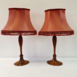 A pair of carved walnut lamp bases, 47 cm high