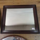 A mahogany wall mirror, 65 x 54 cm, and four oval mirrors (5)