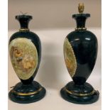 A pair of painted wooden lamp bases, decorated figures, 50 cm high