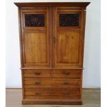 An early 20th century walnut linen press, with two doors, to reveal slides, on a base with two