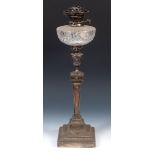 An Edward VII silver oil lamp, with a clear glass well, Sheffield 1902, 64 cm high glass reservoir