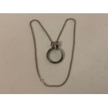 A silver fox head magnifying glass pendant, on a silver chain Modern