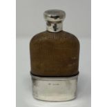 A Victorian glass, rattan mounted and silver flask, initialed, with detachable cup, marks indistinct