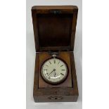 A silver open face pocket watch, in a travelling wooden case