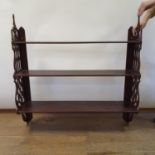 A mahogany fret carved wall shelf, 94 cm wide