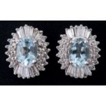 A pair of 18ct gold, aquamarine and diamond halo set stud earrings Oval-cut aquamarines 1.35ct
