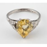 An 18ct gold and platinum ring, set a pear shape sapphire within a mount with small diamonds, ring