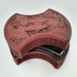 A Chinese cinnabar lacquered box, of shaped form, decorated two figures, 11 cm wide