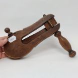 An early 20th century walnut football rattle, 25 cm wide