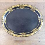 A 19th century oval papier-mâché tray, highlighted in gilt, 65 cm wide Various losses to the edges