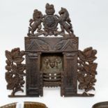 A 19th century cast iron miniature fireplace, 30 x 28 cm, and two cast metal jelly molds (3)