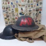 A WWII metal helmet, another, a gas mask, and various military silks sewn together (4)