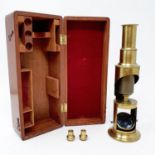 A 19th century brass monocular microscope, 21 cm high, in fitted mahogany case