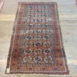 An Afghan red ground rug, 223 x 129 cm