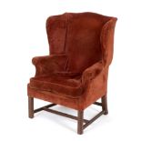 A wing back armchair, on mahogany legs