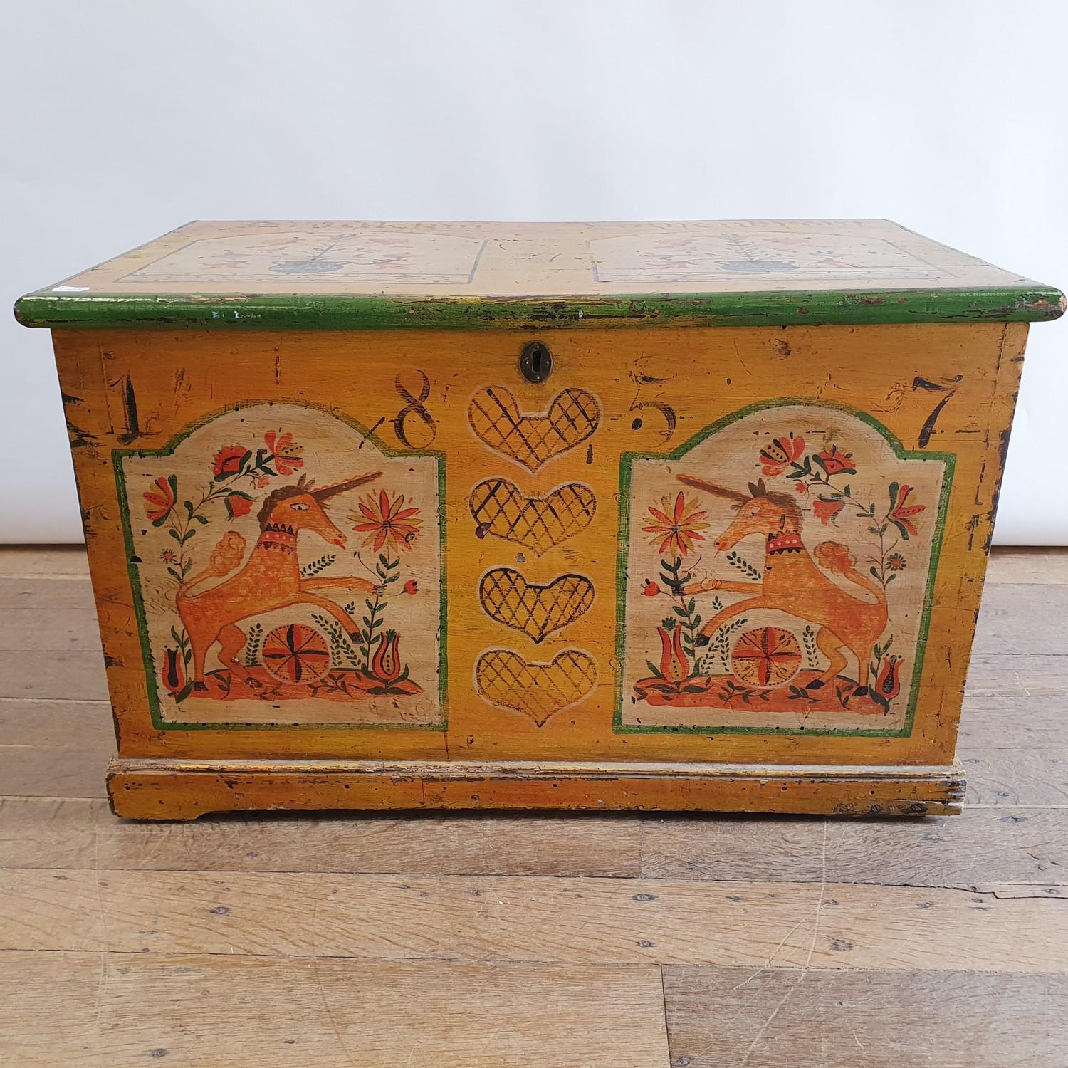 A 19th century painted trunk, decorated unicorns and flowers, painted 1857, 91 cm wide