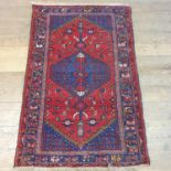 A Persian red ground rug, multiple borders, central medallion, 150 x 110 cm