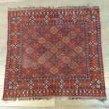 A Persian type red ground rug, 80 x 86 cm, and a prayer mat, 122 x 82 cm (2)