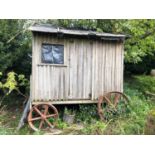 A late Victorian/Edwardian shepherd's hut, of traditional design, on metal wheels For replacement,