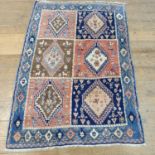 A Persian blue ground rug, multiple borders, centered with six blossom shaped medallions, 150 x