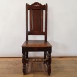 An 18th century oak high back chair, with a panel back and seat, 104 cm high