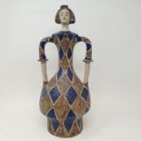 An art pottery vase and cover, in the form of a harlequin, 46 cm high